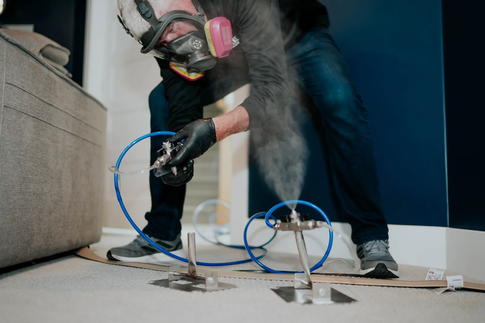 A PureAire Technology technician running a VaPURE treatment in a Miami living room